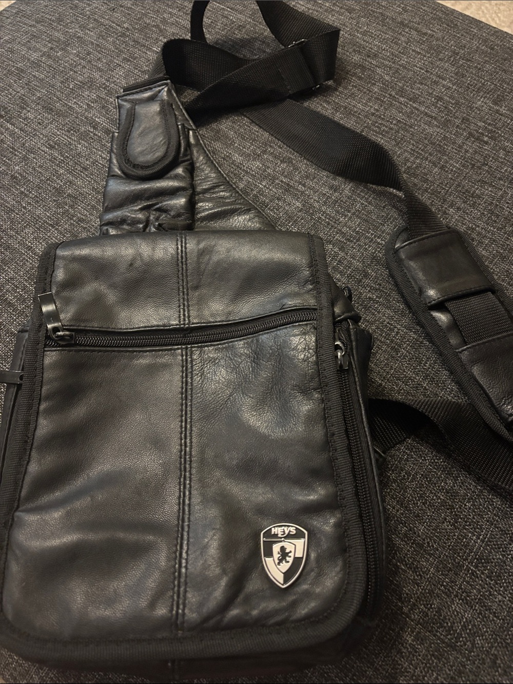 Heys Travelmate black leather sling bag distinctive shield logo for women/men